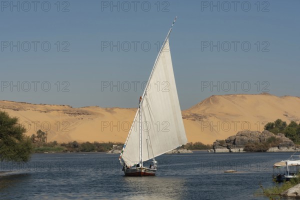 Aswan, Egypt. December 10th 2022 Beautiful landscape view of an Egyptian Felucca sail boat along
