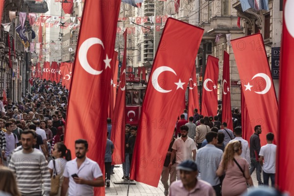 Istanbul, Turkey. October 29th 2023 Crowds flock between the many flags in Istiklal Street,