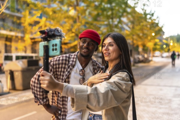 Diverse couple recording engaging video content on a smartphone with a gimbal stabilizer, producing