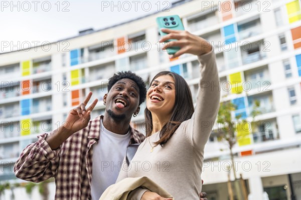 Multiethnic couple enjoying leisure time together, standing outdoors in front of a colorful modern
