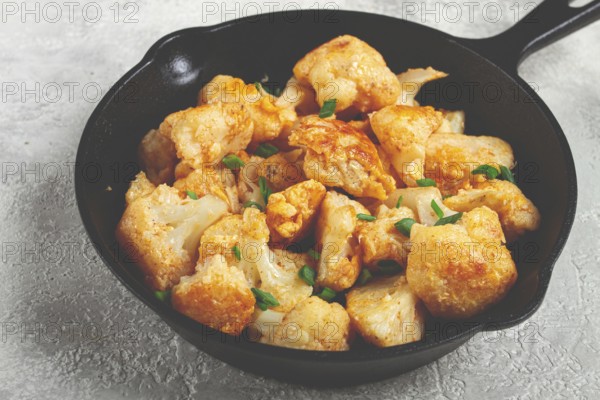 Fried cauliflower, with spices and herbs, in a cast-iron pan, homemade, no people
