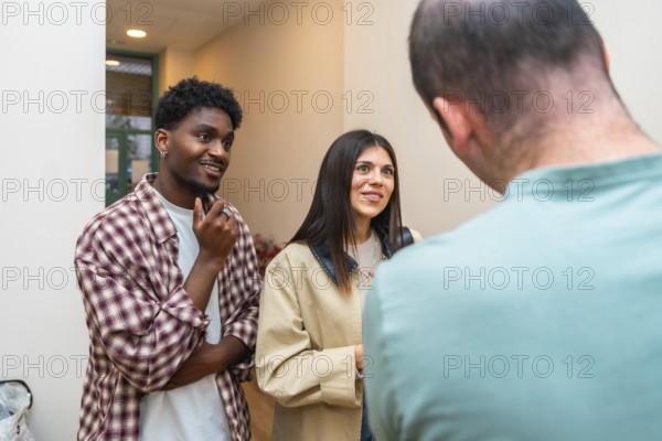 Diverse group of three young adults connecting in a casual indoor setting, actively listening and