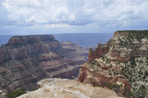 Deeply cut rock canyons with dramatic cliffs under a cloudy sky, Grand Canyon National Park,