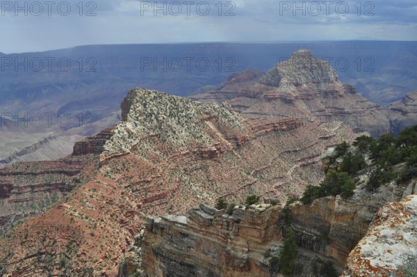 Extensive canyon landscape with rugged rock structure and bright light on an extensive rock chain,