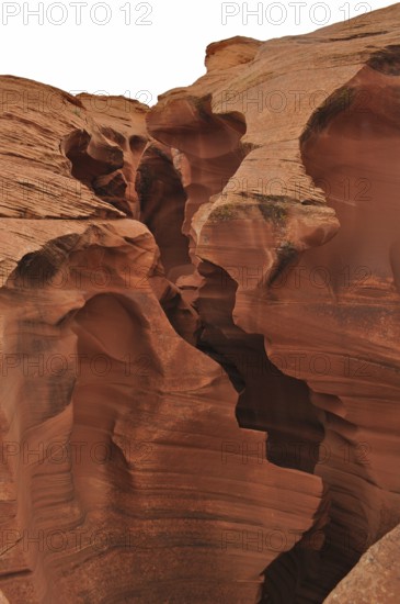 Massive sandstone structures with dramatic fissures, entrance to Antelope Canyon, Navajo Nation