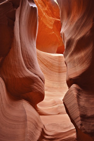 Strong shadows in a dramatic sandstone gorge in shades of orange with bright colors, Antelope