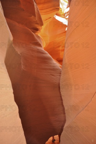 Narrow passage of smooth orange sandstone forming a natural rock formation, Antelope Canyon, Navajo