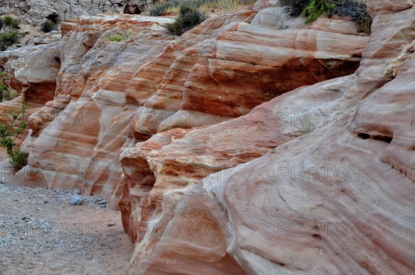 Close-up of detailed, erosion-shaped red and gray rocks with various layers and textures, Valley of