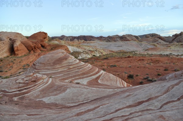 Rock formations with distinctive red and white stripes under a blue sky, Valley of Fire State Park,