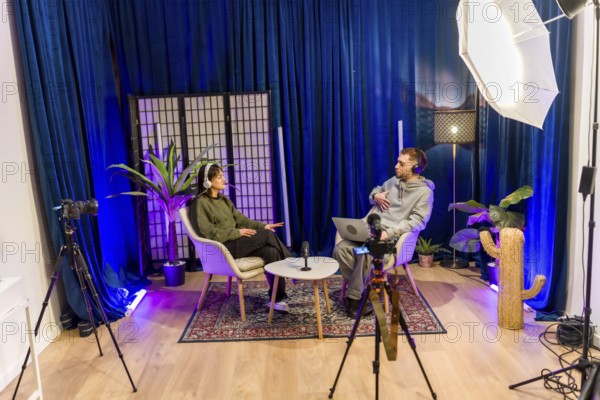 Young diverse people recording a social media podcast in a professional studio, creating digital