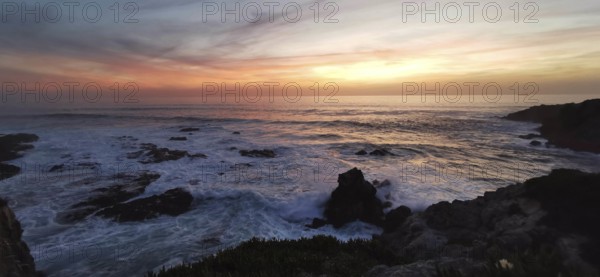 Sunset over the sea, gentle waves and rocks in a tranquil atmosphere, hiking on the Fisherman's
