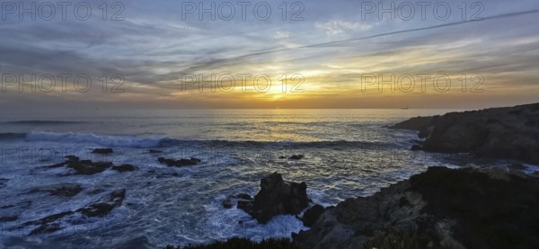 A breathtaking sunset over the sea with dramatic waves and rocks, hiking the Fisherman's Trail,