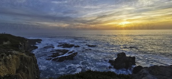 The golden sun sets over the vast sea, illuminated by bright clouds, hiking on the Fisherman's