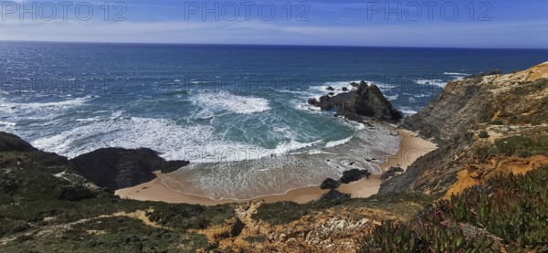 Waves break on a secluded sandy beach surrounded by rocks under a clear sky, hiking the Fisherman's