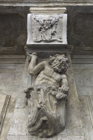 Sculpture of a man, Atlant under a 19th century balcony, Lviv, Ukraine
