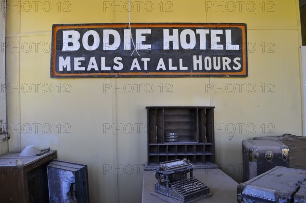 Sign of an old hotel with antique objects such as a typewriter, Bodie Hotel, Bodie Ghost Town,