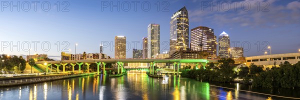 Tampa skyline with skyscrapers and bridge over Hillsborough River at night panorama in downtown