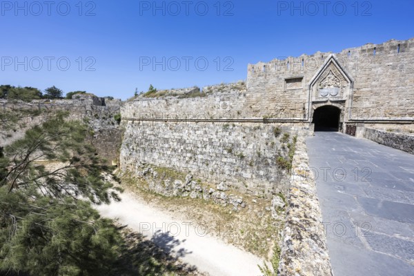 Red gate from the Middle Ages in the city wall of the historic old town on the island of Rhodes,