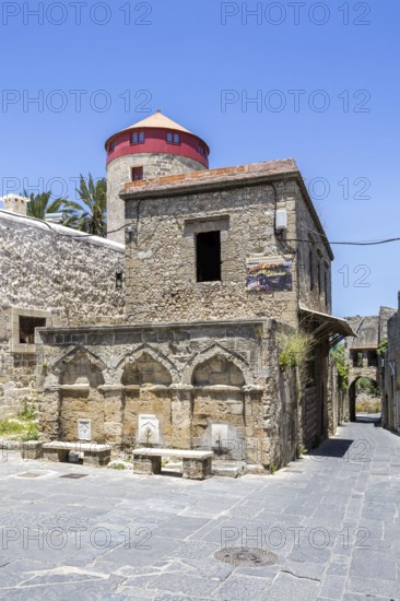 Ottoman fountain and windmill in the historic old town from the Middle Ages on the island of