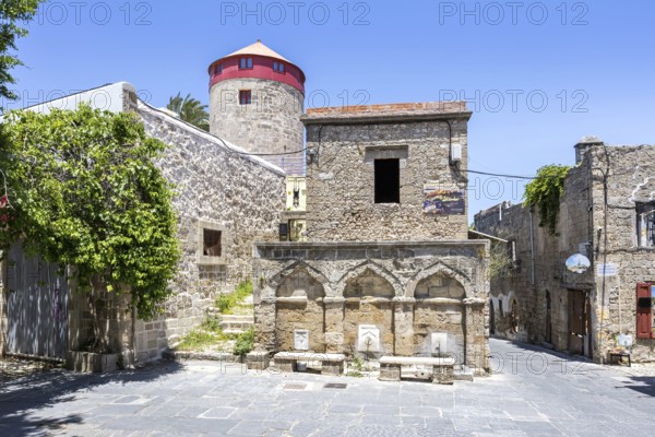 Ottoman fountain and windmill in the historic old town from the Middle Ages on the island of