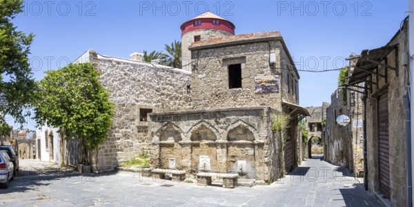 Ottoman fountain and windmill in the historic old town from the Middle Ages panorama on the island