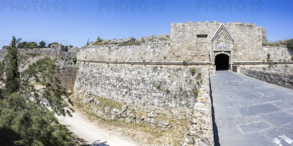 Red gate from the Middle Ages in the city wall of the historic old town Panorama on the island of