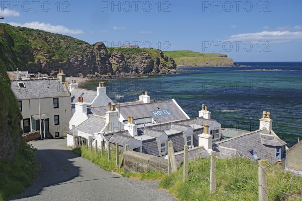 Village with hotel on coast with dramatic cliffs and blue water, Local Hero, Pennan, Aberdeenshire,
