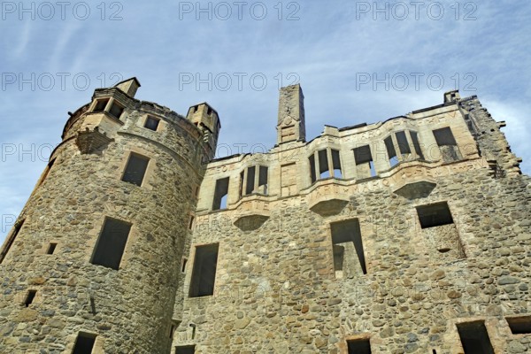 Stone castle ruins with old towers and windows under a clear blue sky, Huntly Aberdeenshire,