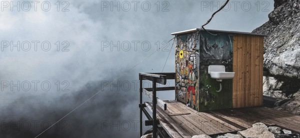 Colourful toilet at the Chata pod Rysmi mountain hut on a wooden platform in the middle of a