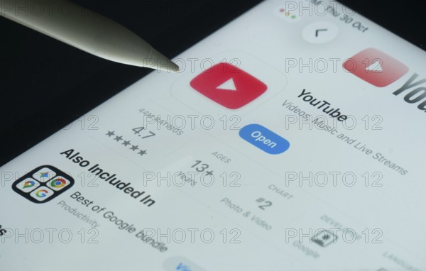 Dhaka, Bangladesh- 30 Oct 2025: Youtube app on a iPad screen with a pen pointing at the install