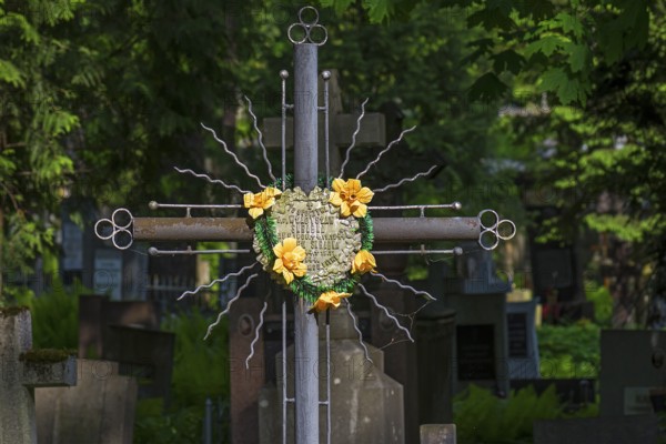 Artificial flower mix on a cross, Lützenhofer cemetery Lychakivsky cemetery, Lviv, Galicia, Ukraine