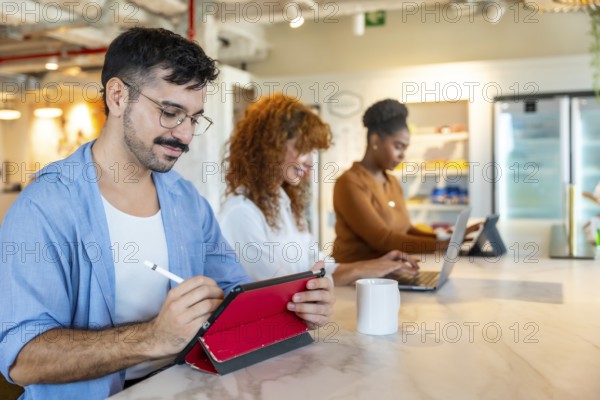 Diverse colleagues working on personal devices in a modern office, focusing on tasks and