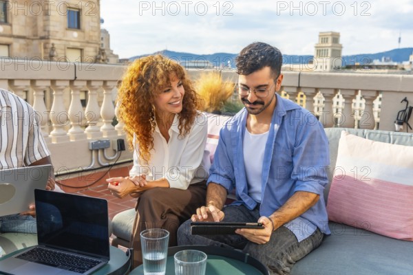Two diverse colleagues collaborating during an outdoor business meeting on a professional coworking