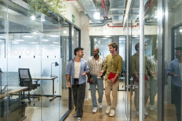 Diverse business colleagues walking and talking in a contemporary coworking office during a break,