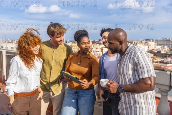 Diverse business people standing on a sunny urban rooftop, networking and collaborating while