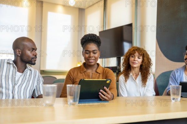 Diverse business colleagues are engaging in a collaborative meeting, discussing ideas and working