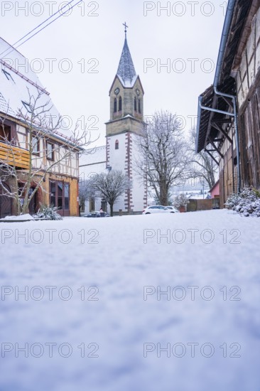 Historic church tower in a snowy village, quiet and rural winter atmosphere, Gechingen, Calw