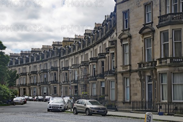 A curve with elegant townhouses and parked cars in a residential area, Newtown, Edinburgh,