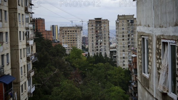 Old high-rise buildings with views of the city and surrounding trees, nostalgic curtain blowing