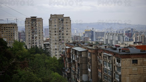 Urban panorama with high-rise buildings in a residential district of Tbilisi and hilly landscape,