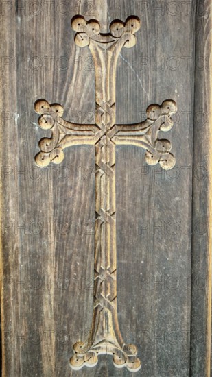 A detailed carved wooden cross on a wooden wall as decoration, Orthodox, Armenia