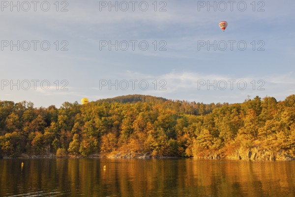Hot air balloons over the Brno Reservoir (Brnenská prehrada) on the Svratka River on a sunny autumn