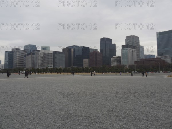 Cityscape with skyscrapers under a grey sky surrounded by a wide plain, Kokyo-gaien, Tokyo, Japan
