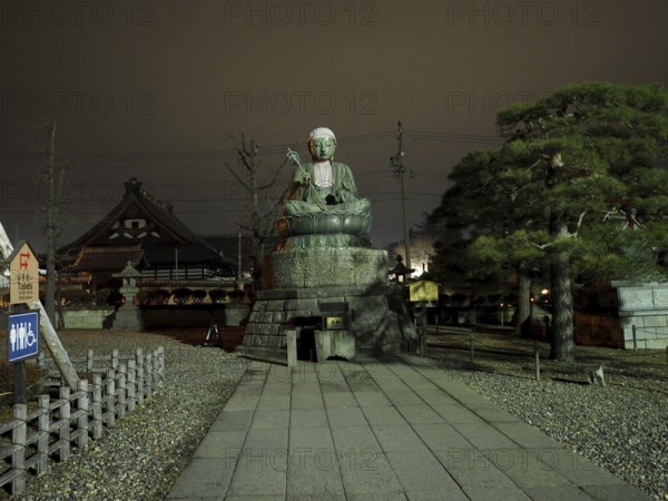 Large Buddha statue in front of a temple, calm atmosphere at night, Zenko-ji Temple, Nagano, Japan
