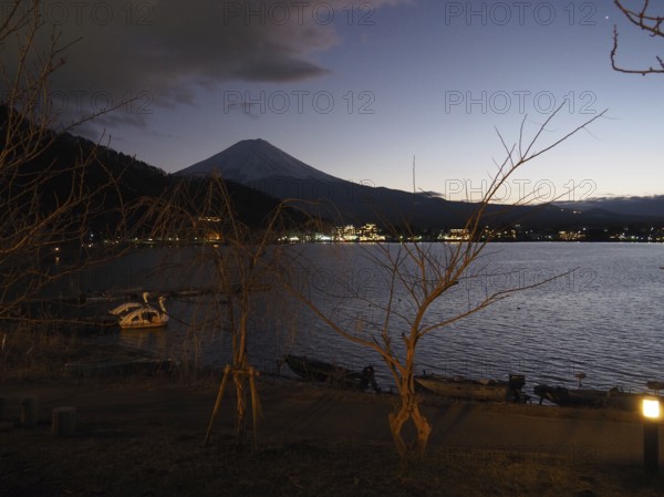 View of lake at night with Mount Fuji in the background and calm atmosphere, Lake Kawaguchiko,