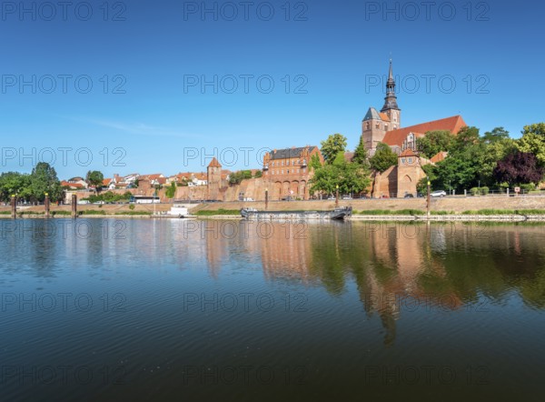 View across the Elbe harbor to the old town with St. Stephen's church and city wall, brick
