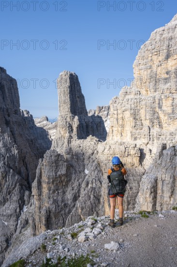 Female hiker in front of Campanile Alto and Cima Brenta Alta, Bocchette Centrale band trail, via