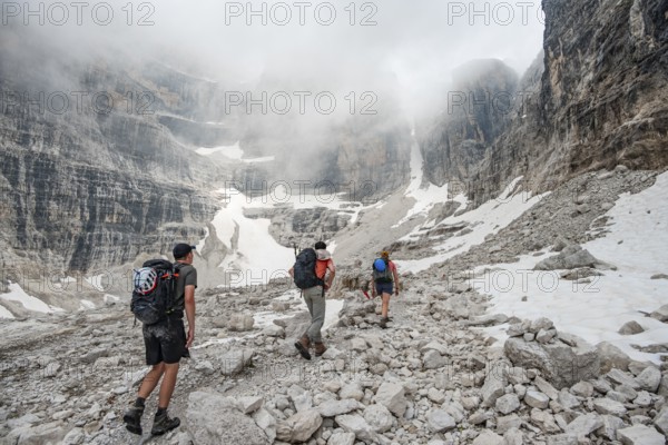 Hikers climbing the Via Ferrata Oliva Detassis, rocky mountain peaks and mountain scenery, Brenta