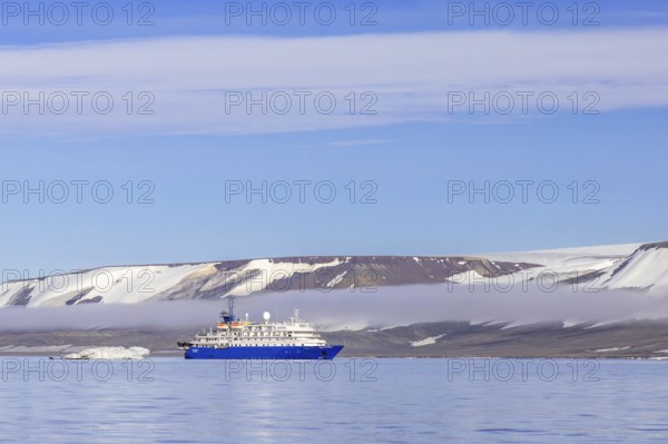 Antarctic cruise ship MV Sea Spirit of Poseidon Expeditions with eco-tourists cruising along the