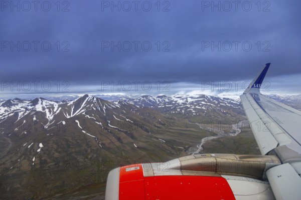 Airplane wing and aerial view over Adventdalen in summer, 30-kilometre valley and river
